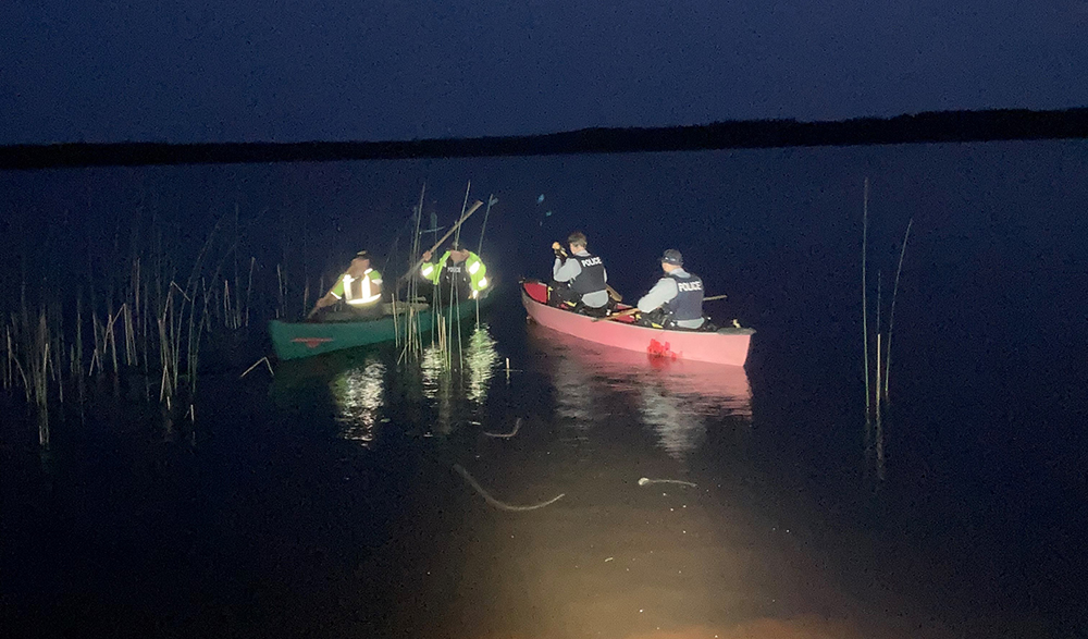 Mounties say they paddled approximately one kilometer across a lake to rescue a pair of stranded boaters, who were found in good health.
