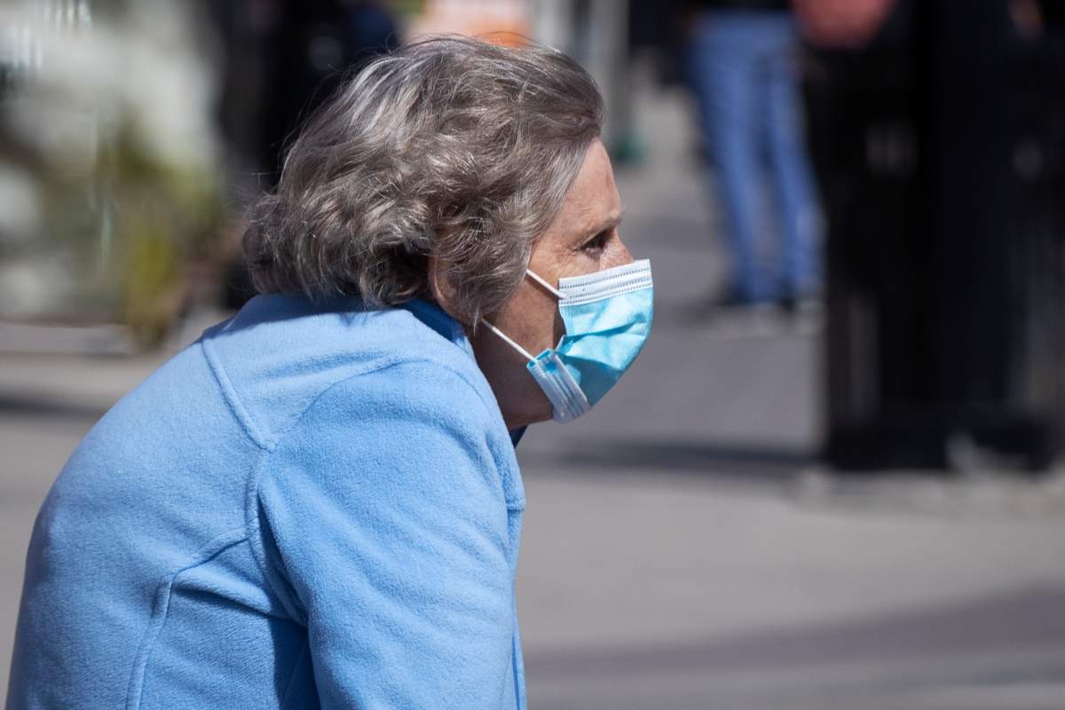 A senior wears a surgical mask to protect them from the COVID-19 virus in Kingston, Ontario on Monday May 10, 2021. 
