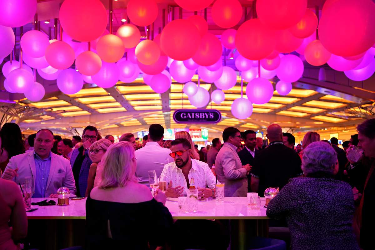 People walk by an illuminated sphere during the the opening night of the Resorts World Las Vegas hotel-casino, Thursday, June 24, 2021, in Las Vegas.