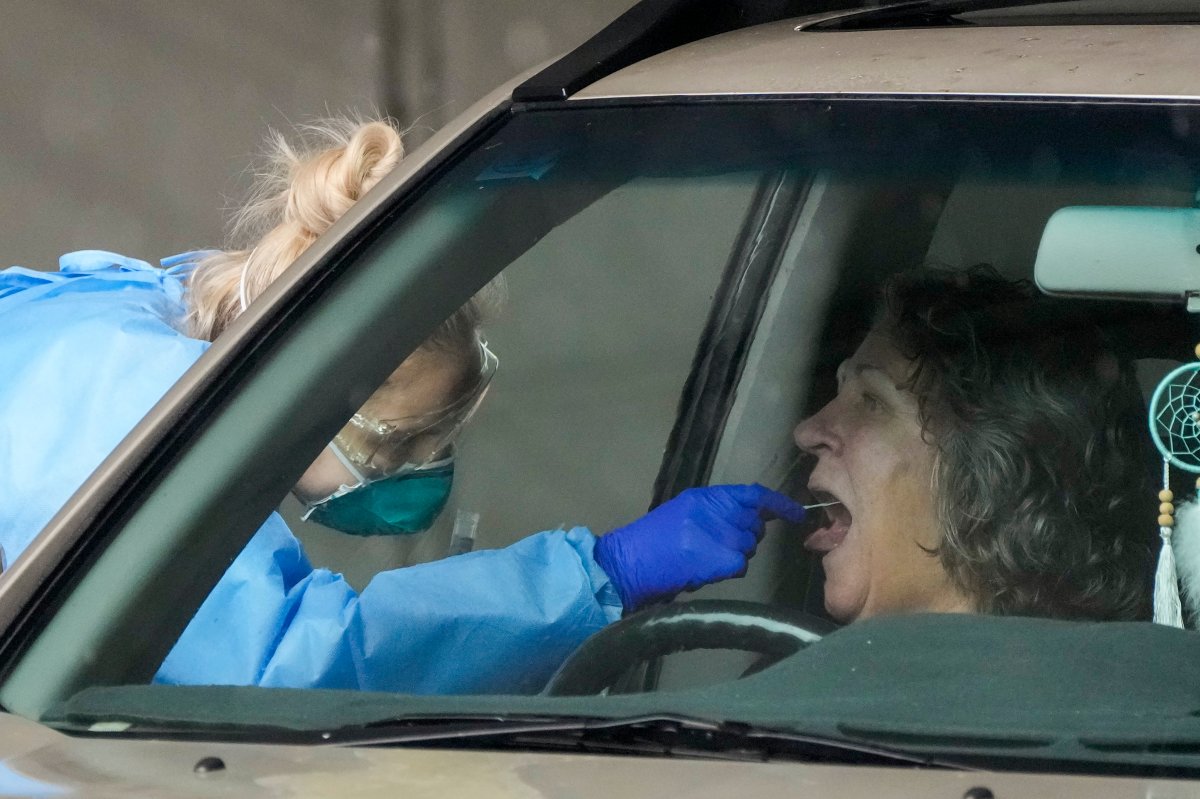 A woman receives a COVID-19 test at a testing station in Nelson Bay, Australia, Monday, June 28, 2021.