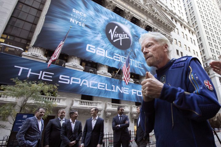 FILE - In this Monday, Oct. 28, 2019 file photo, Richard Branson, right, founder of Virgin Galactic, and company executives gather for photos outside the New York Stock Exchange before his company's IPO. 