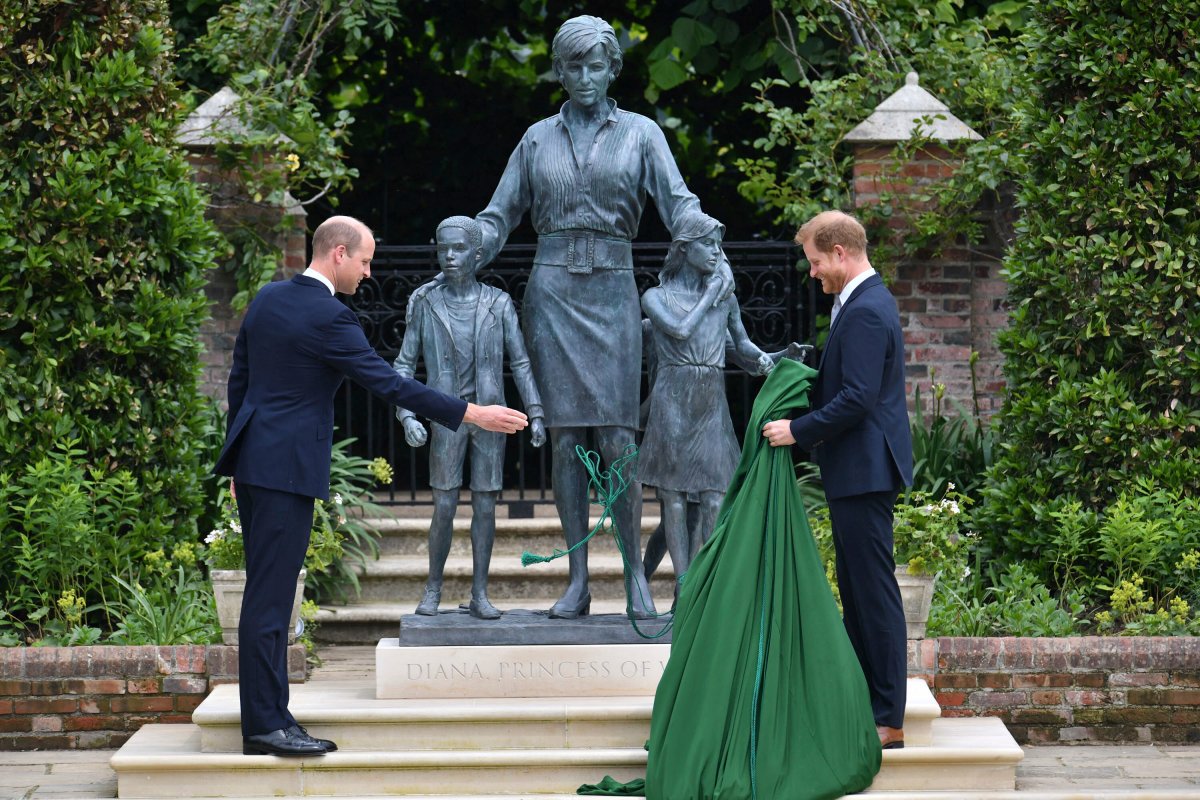 Britain's Prince William, left and Prince Harry unveil a statue they commissioned of their mother Princess Diana, on what woud have been her 60th birthday, in the Sunken Garden at Kensington Palace, London, Thursday July 1, 2021.