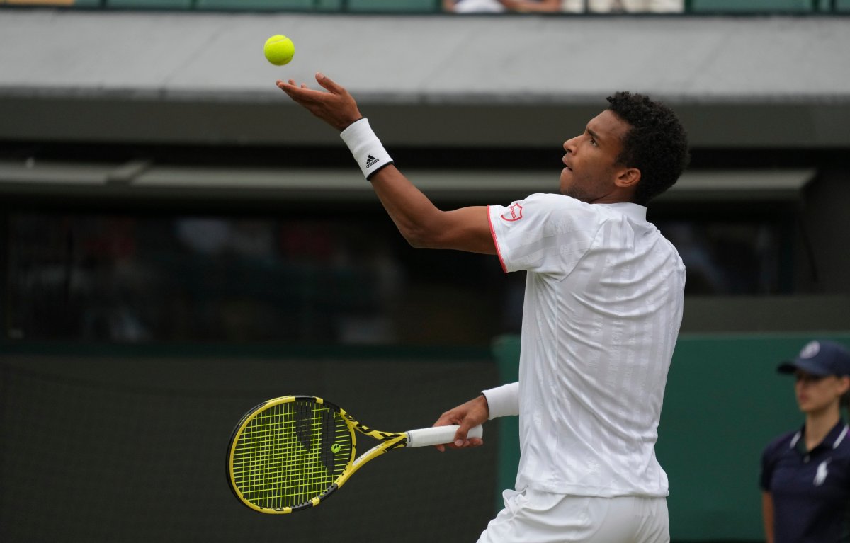 Canada's Felix Auger-Aliassime serves to Australia's Nick Kyrgios during the men's singles third round match on day six of the Wimbledon Tennis Championships in London, Saturday July 3, 2021. 
