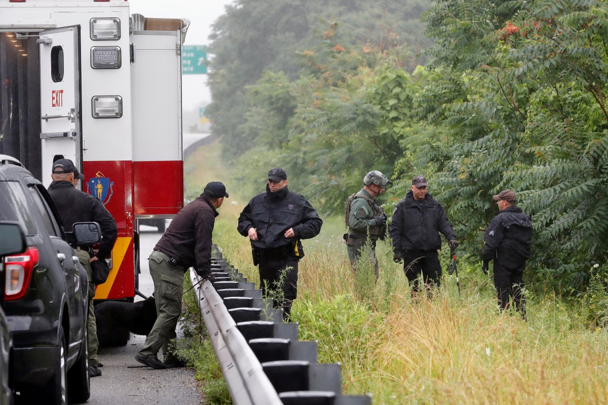 Police work in the area of an hours long standoff with a group of armed men that partially shut down interstate 95, Saturday, July 3, 2021, in Wakefield, Mass.