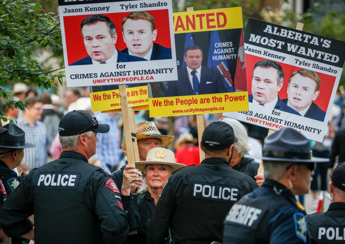Protesters shout slogans as Alberta Premier Jason Kenney hosts the Premier’s annual Stampede breakfast in Calgary, Alta., Monday, July 12, 2021.
