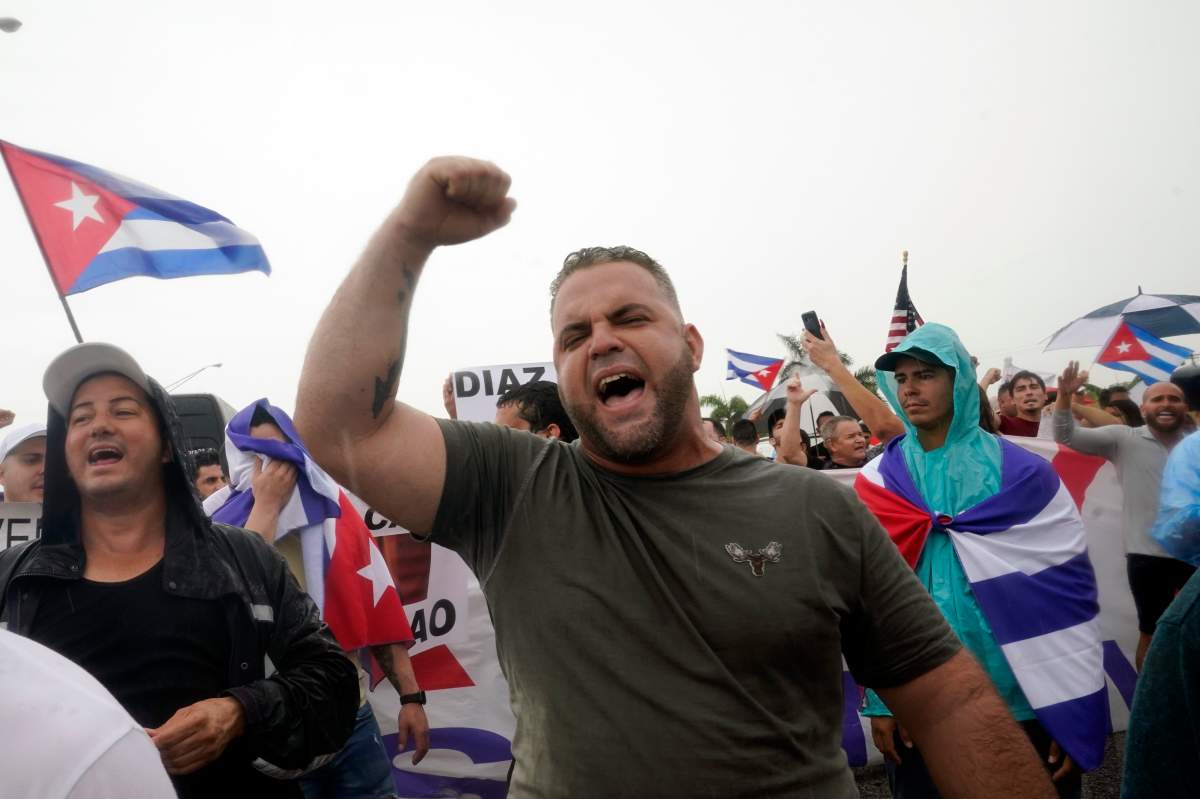 Demonstrators walk on both lanes of the Palmetto Expressway, Tuesday, July 13, 2021, in Miami.