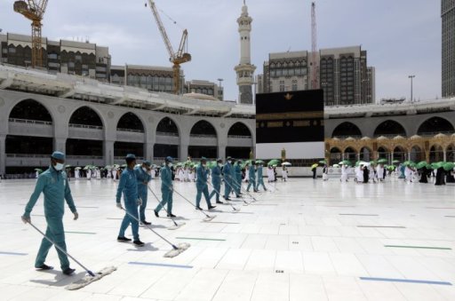 Workers disinfect the grounds as Muslim pilgrims circumambulate around the Kaaba, the cubic building at the Grand Mosque, a day before the annual hajj pilgrimage, Saturday, July 17, 2021.