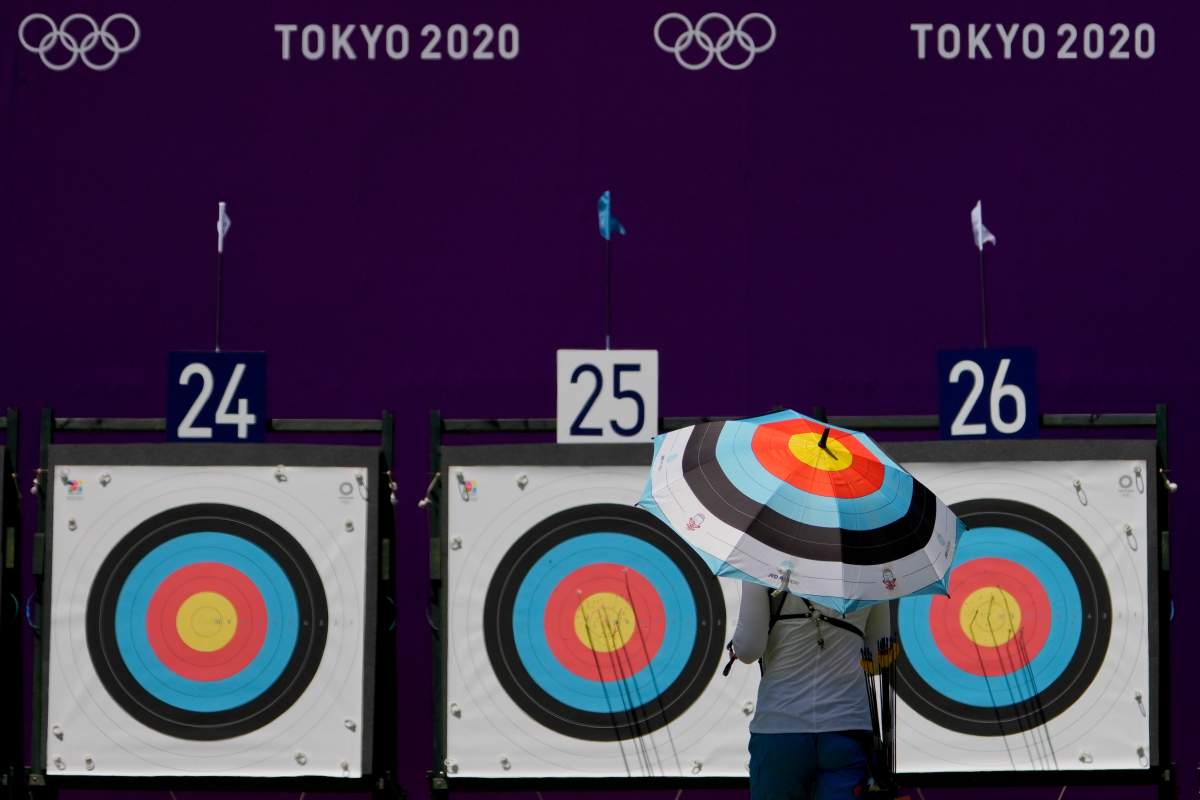 FILE -- An athlete from Ukraine walks to collect her arrows as she practices for the 2020 Summer Olympics at Yumenoshima Park Archery Field, Sunday, July 18, 2021, in Tokyo. (AP Photo/Charlie Riedel).