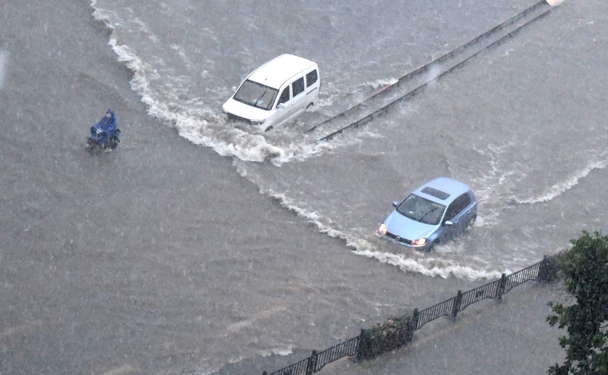 ZHENGZHOU, July 20, 2021 Vehicles run on a waterlogged road in Zhengzhou, capital of central China’s Henan Province, July 20, 2021. Credit Image: © Zhu Xiang/Xinhua via ZUMA Press