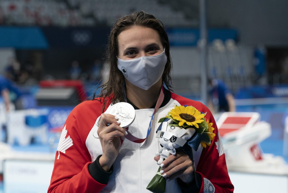 Canadian swimmer Kylie Masse, from LaSalle, Ont. holds up her silver medal in the women's 200m backstroke at the Tokyo Olympics, Saturday, July 31, 2021 in Tokyo, Japan. THE CANADIAN PRESS/Adrian Wyld.