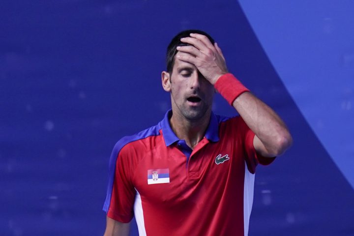 Novak Djokovic, of Serbia, reacts during the bronze medal match of the tennis competition against Pablo Carreno Busta, of Spain, at the 2020 Summer Olympics, Saturday, July 31, 2021, in Tokyo, Japan. 