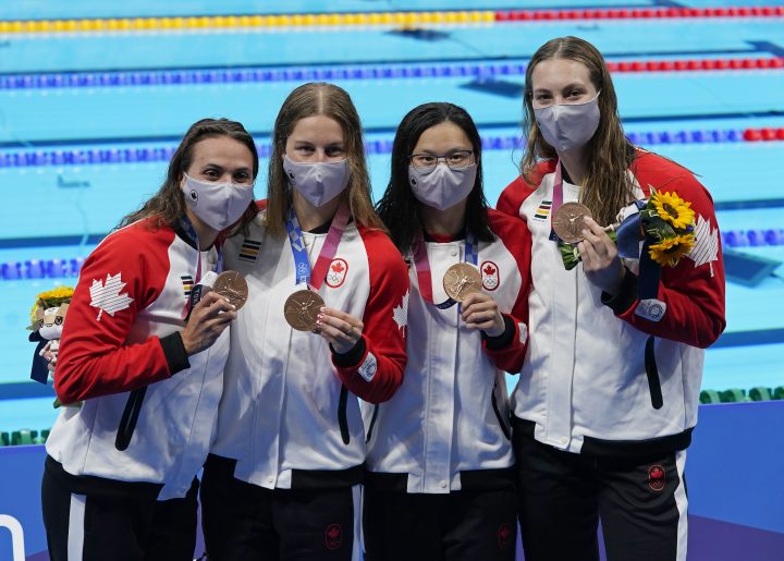 Canada’s Kylie Masse, left to right, Sydney Pickrem, Maggie Mac Neil and Penny Oleksiak celebrate a bronze medal in the women’s 4 x 100m medley relay final during the Tokyo Summer Olympic Games, in Tokyo, Sunday, August 1, 2021.