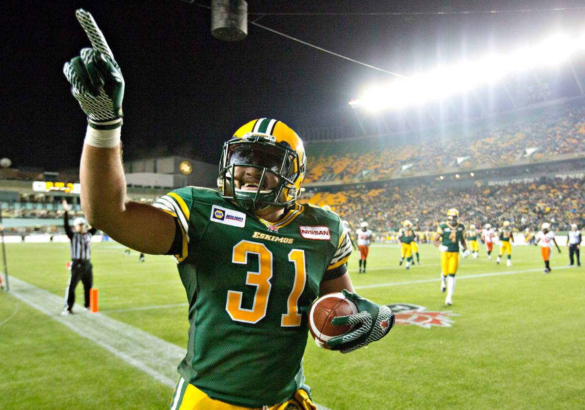 Edmonton Eskimos Calvin McCarty (31) celebrates a touchdown against the B.C. Lions during second half CFL action in Edmonton, Alta., on Saturday Nov. 1, 2014.