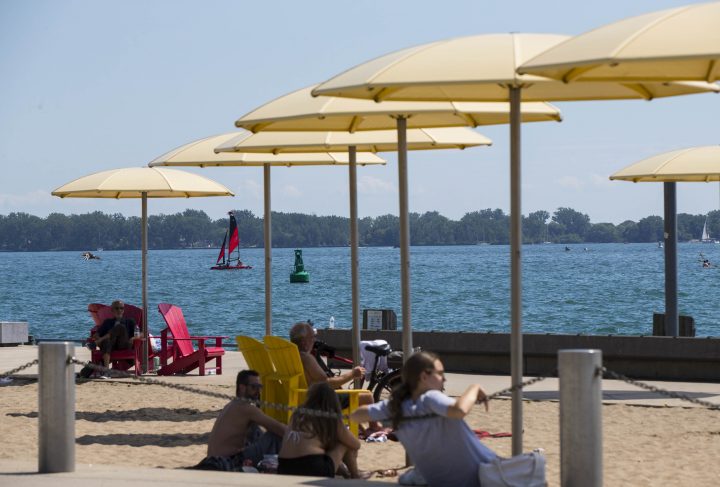 People cool off at a park in Toronto on Aug. 23, 2020.