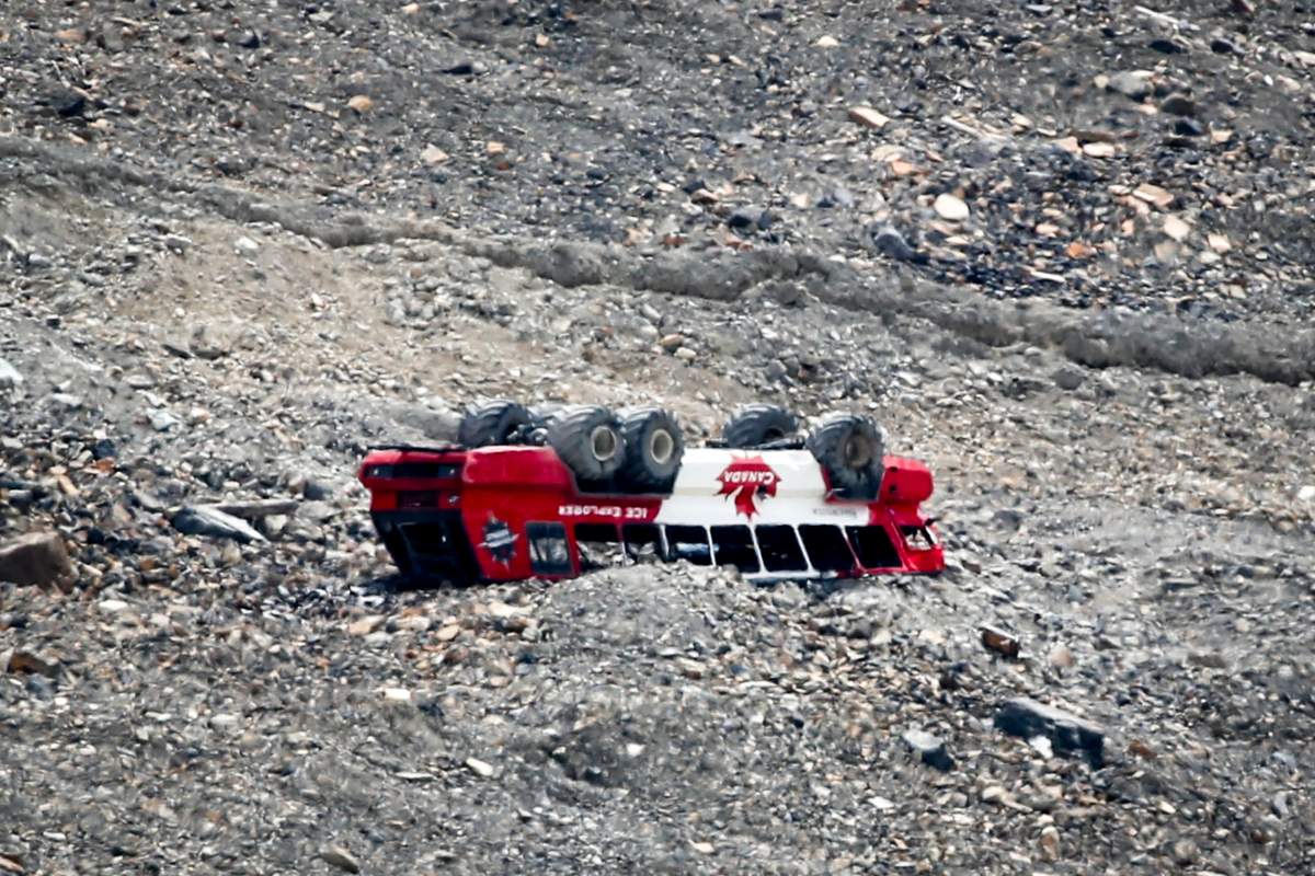 A rolled-over tour bus rests where it fell on the Columbia Icefield near Jasper, Alta., Sunday, July 19, 2020.