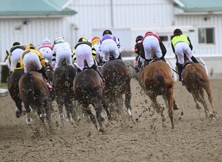 Horses kick up dirt as jockeys ride on the first corner during the running of the 161st Queen's Plate at Woodbine Racetrack in Toronto on Saturday, September 12, 2020.