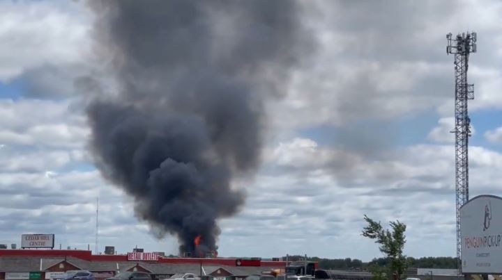 The blaze started at the building's back loading dock, prompting several small propane cylinders to explode, local deputy fire chief Ed Davis confirmed.