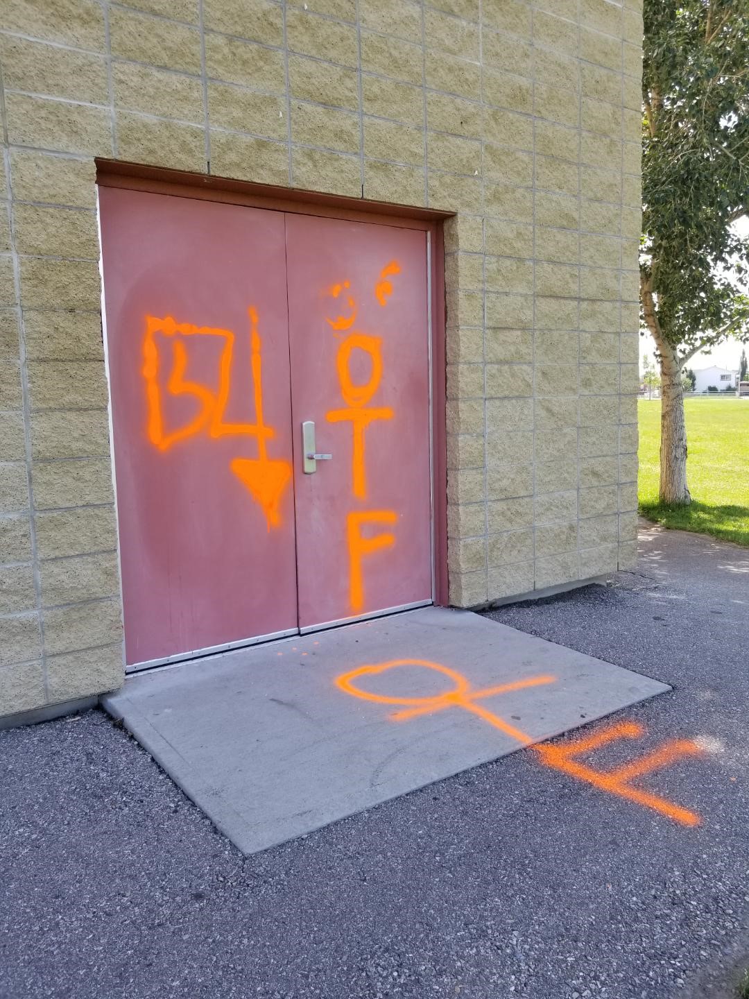 Graffiti is spray painted on the side of Muriel Clayton School in Airdrie, Alta, in an undated photo. RCMP are looking for help identifying who is responsible.
