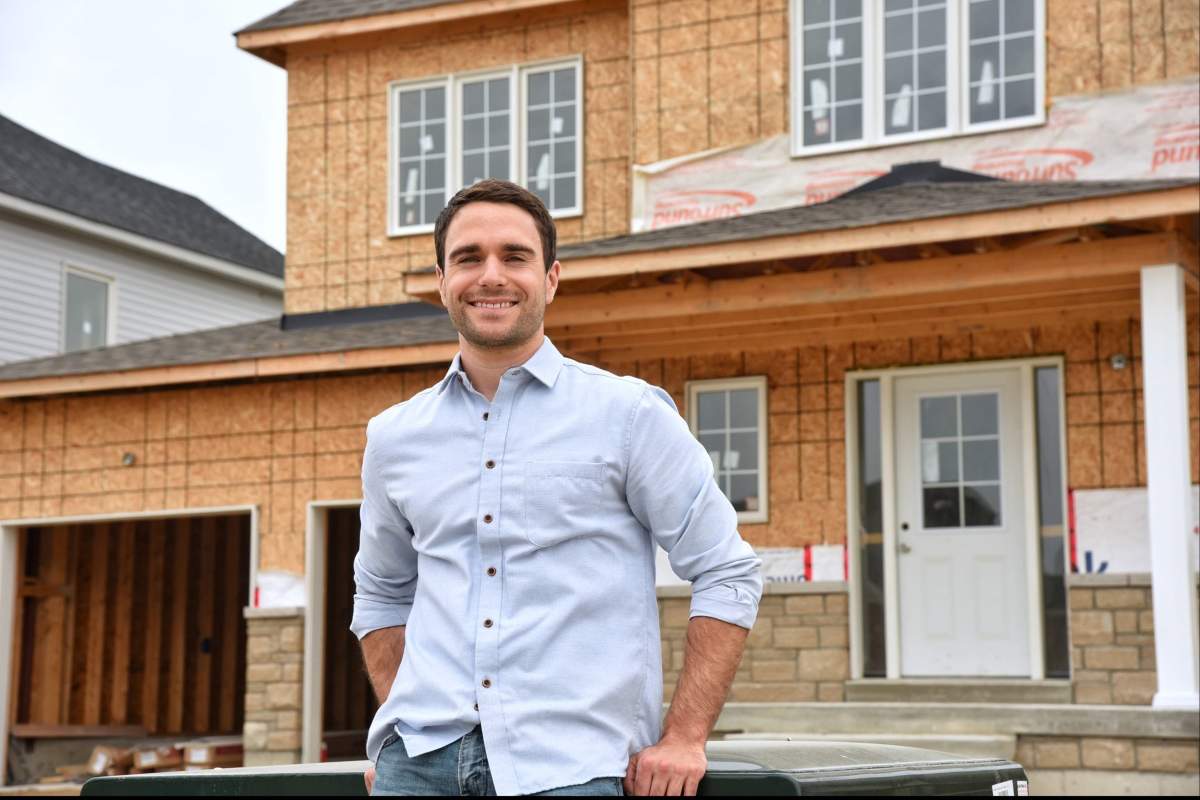Engineering in training Ian Blechta stands in front of his pre-construction house