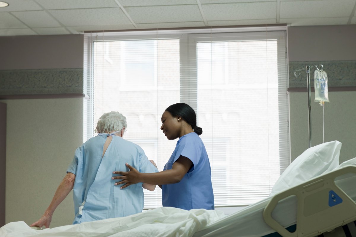 A nurse helping a woman in hospital.