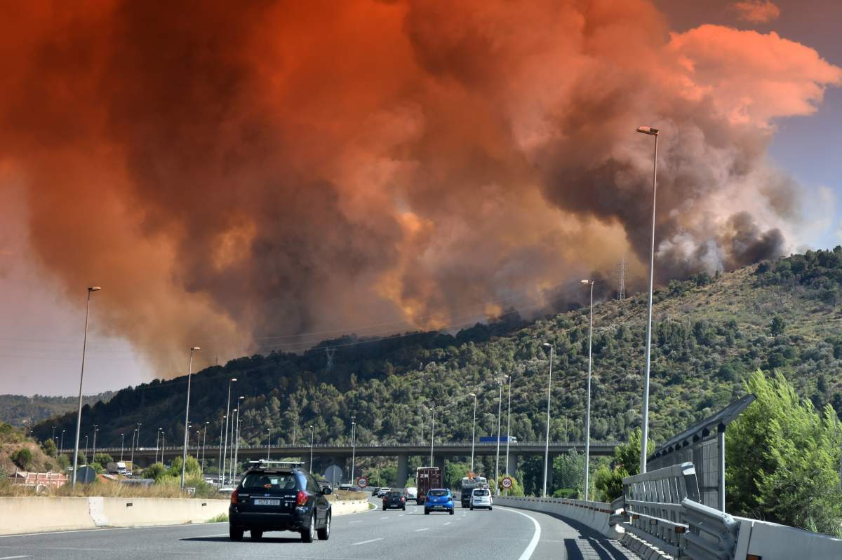 A cloud of smoke and fire in Castellvi de Rosanes seen over A-2 highway in Martorell during the fire.