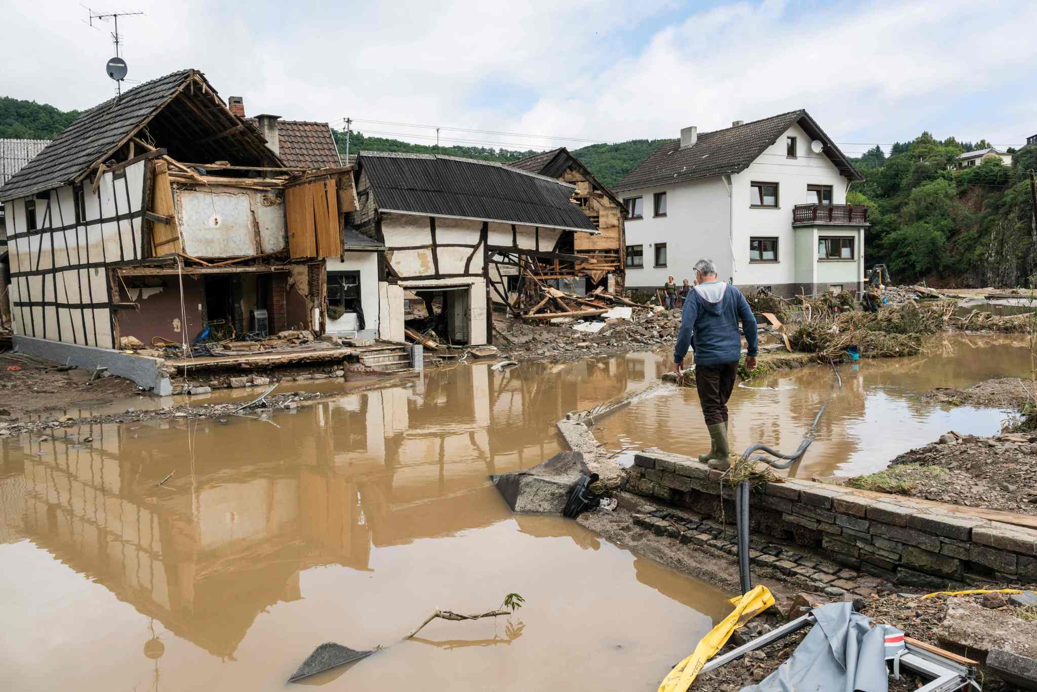 A man walks through the floods towards destroyed houses in Schuld near Bad Neuenahr, western Germany, on July 15, 2021.