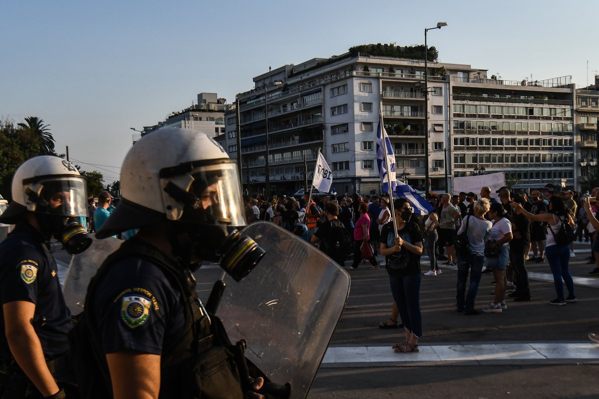 ATHENS, GREECE - JULY 24: Anti-vaccine protesters hold a banners and wave flags as they march to the parliament, in Athens, on Saturday, July 24, 2021. Thousands of people protested against Greek government's measures to curb rising COVID-19 infections. (Photo by Dimitris Lampropoulos/Anadolu Agency via Getty Images).
