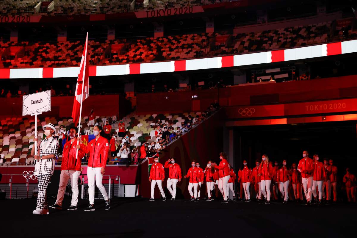Flag bearers Miranda Ayim and Nathan Hirayama of Team Canada lead their team during the Opening Ceremony of the Tokyo 2020 Olympic Games at Olympic Stadium on July 23, 2021 in Tokyo, Japan.