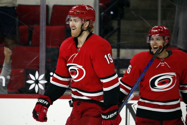 Carolina Hurricanes’ Dougie Hamilton (19) celebrates his game-winning goal with teammate Teuvo Teravainen (86) in overtime of an NHL hockey game against the Columbus Blue Jackets in Raleigh, N.C., Saturday, May 1, 2021.