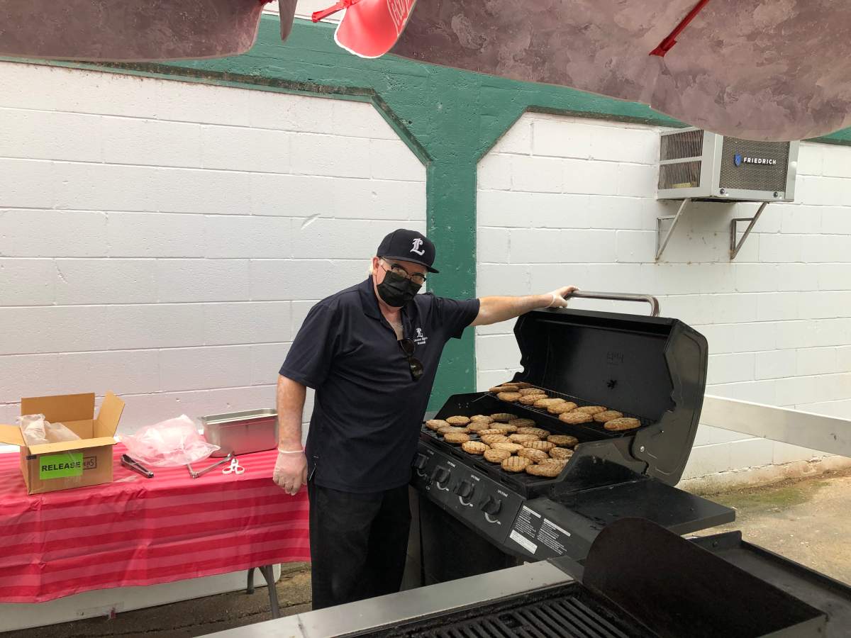 Bill Ross works the barbecue during the London Majors’ home opener against the Toronto Maple Leafs.