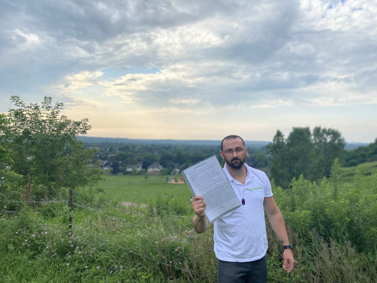 Jeremy Smith holds a copy of the provincial petition which can be found more than 100 cannabis retailers across southwestern Ontario.