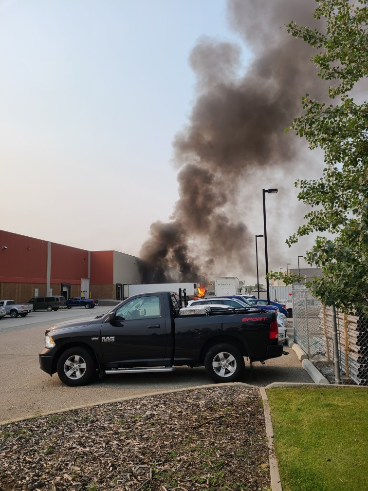 Calgary firefighters battle a blaze at a trailer parked at the loading dock of Stericycle in Southeast Calgary on Wednesday, July 28, 2021.