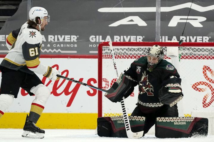 Arizona Coyotes goaltender Darcy Kuemper, right, makes a save on a shot by Vegas Golden Knights right wing Mark Stone (61) during the third period of an NHL hockey game Saturday, May 1, 2021, in Glendale, Ariz. The Golden Knights won 3-2 in overtime.