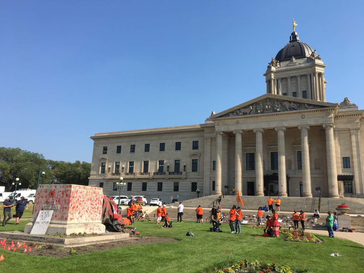 Hand prints made in red paint cover the base of the statue, while more paint was poured on the monument itself.