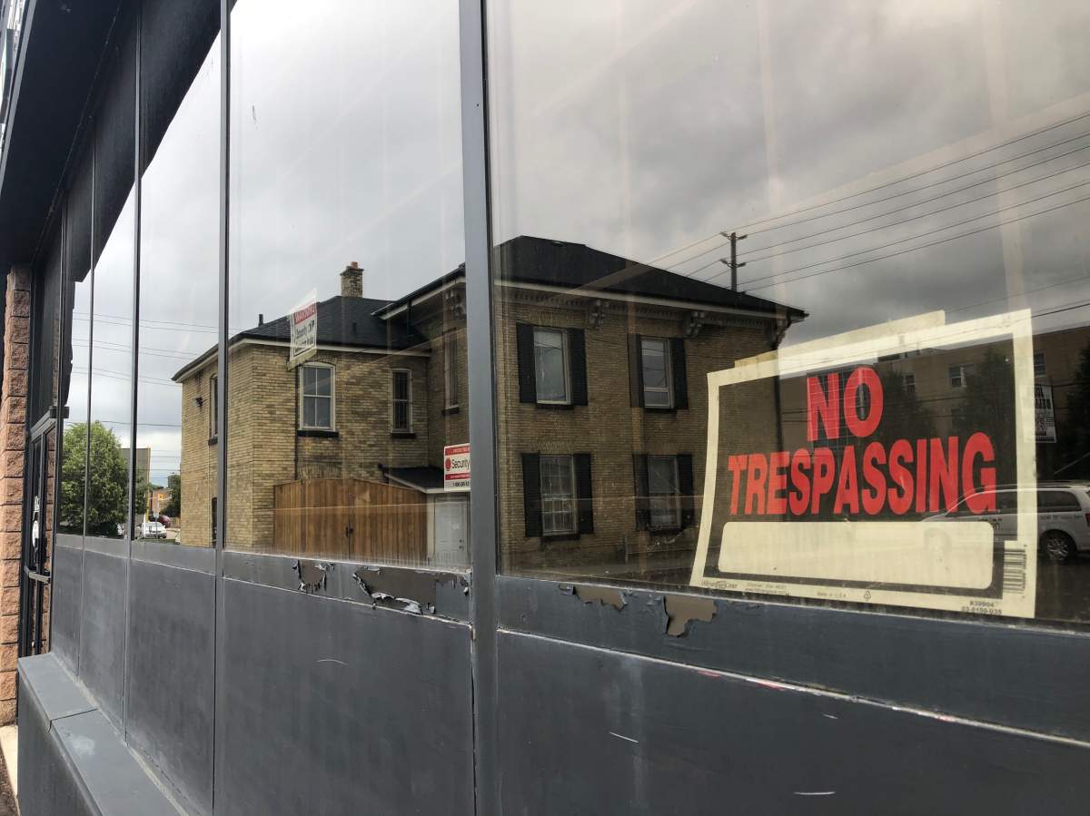 A "no trespassing" hangs in the window of a former musical instrument shop that will soon be retrofitted to accomodate London's first permanent supervised consumption site.