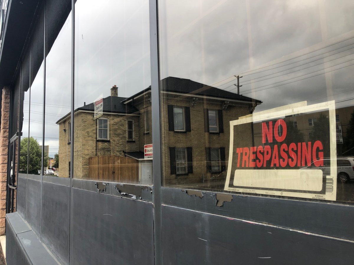A "no trespassing" hangs in the window of a former musical instrument shop that will soon be retrofitted to accomodate London's first permanent supervised consumption site.