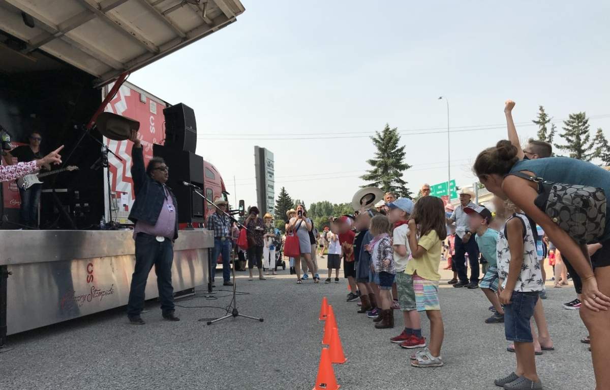Calgary Mayor Naheed Nenshi leads a Stampede breakfast in a cheer of ‘yahoo’ on July 14, 2021.