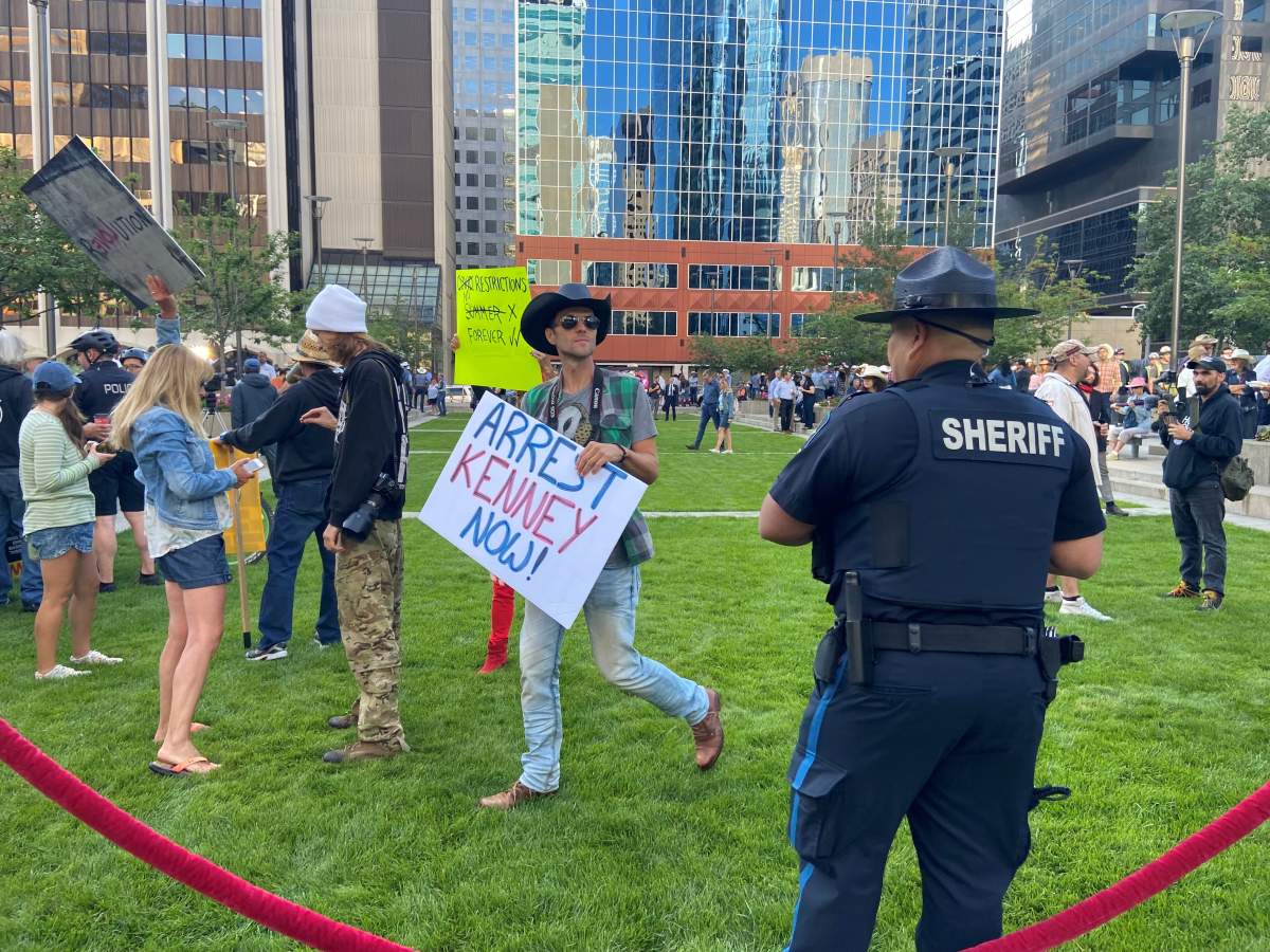 Protesters were seen at a Stampede pancake breakfast hosted by Premier Jason Kenney in Calgary on Monday.