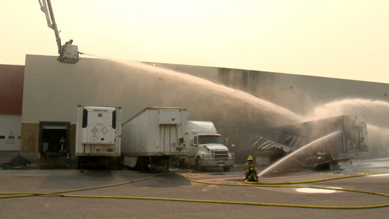 Calgary firefighters battle a blaze at a trailer parked at the loading dock of Stericycle in Southeast Calgary on Wednesday, July 28, 2021.