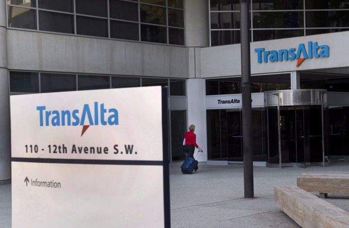 A woman walks towards the entrance of the TransAlta headquarters building in Calgary, on Tuesday, April 29, 2014. 