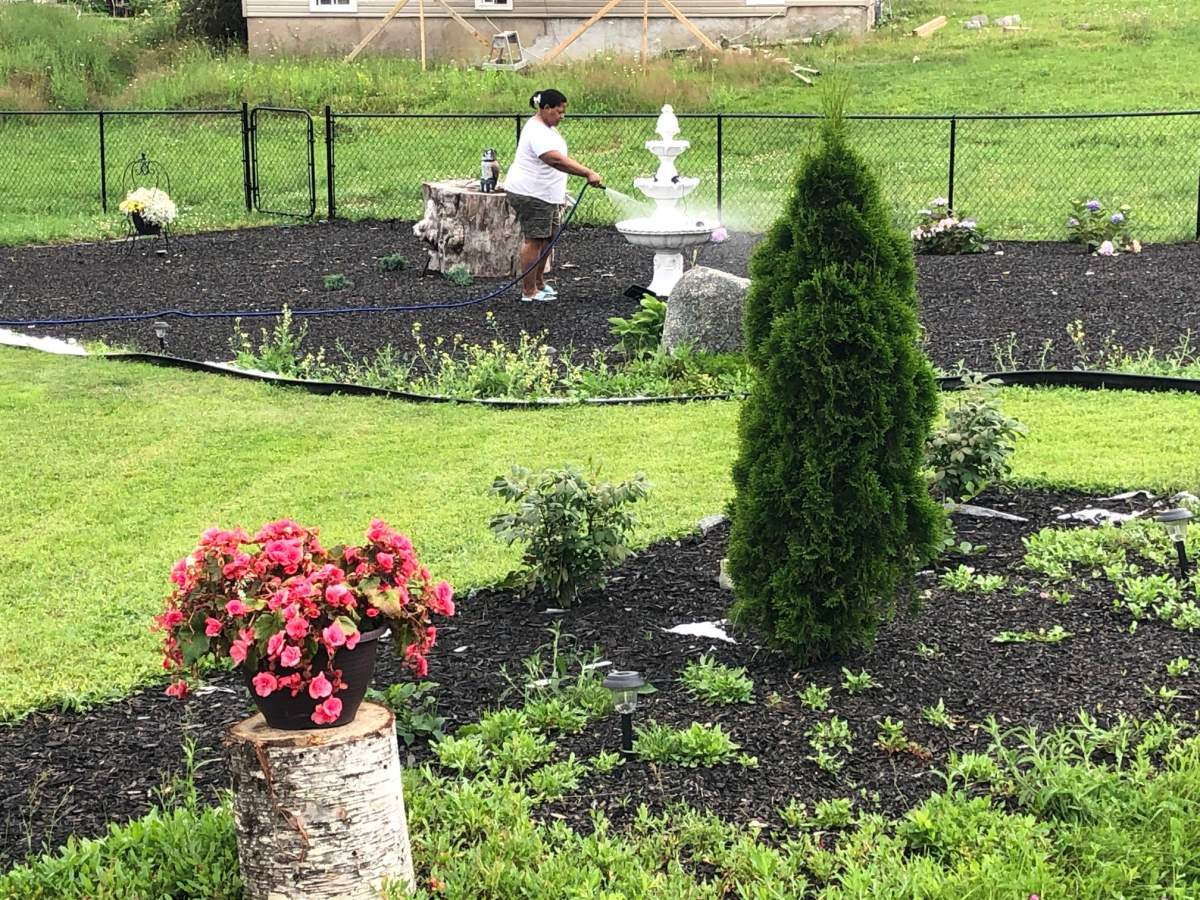A woman works in her garden, in North Preston, Nova Scotia,