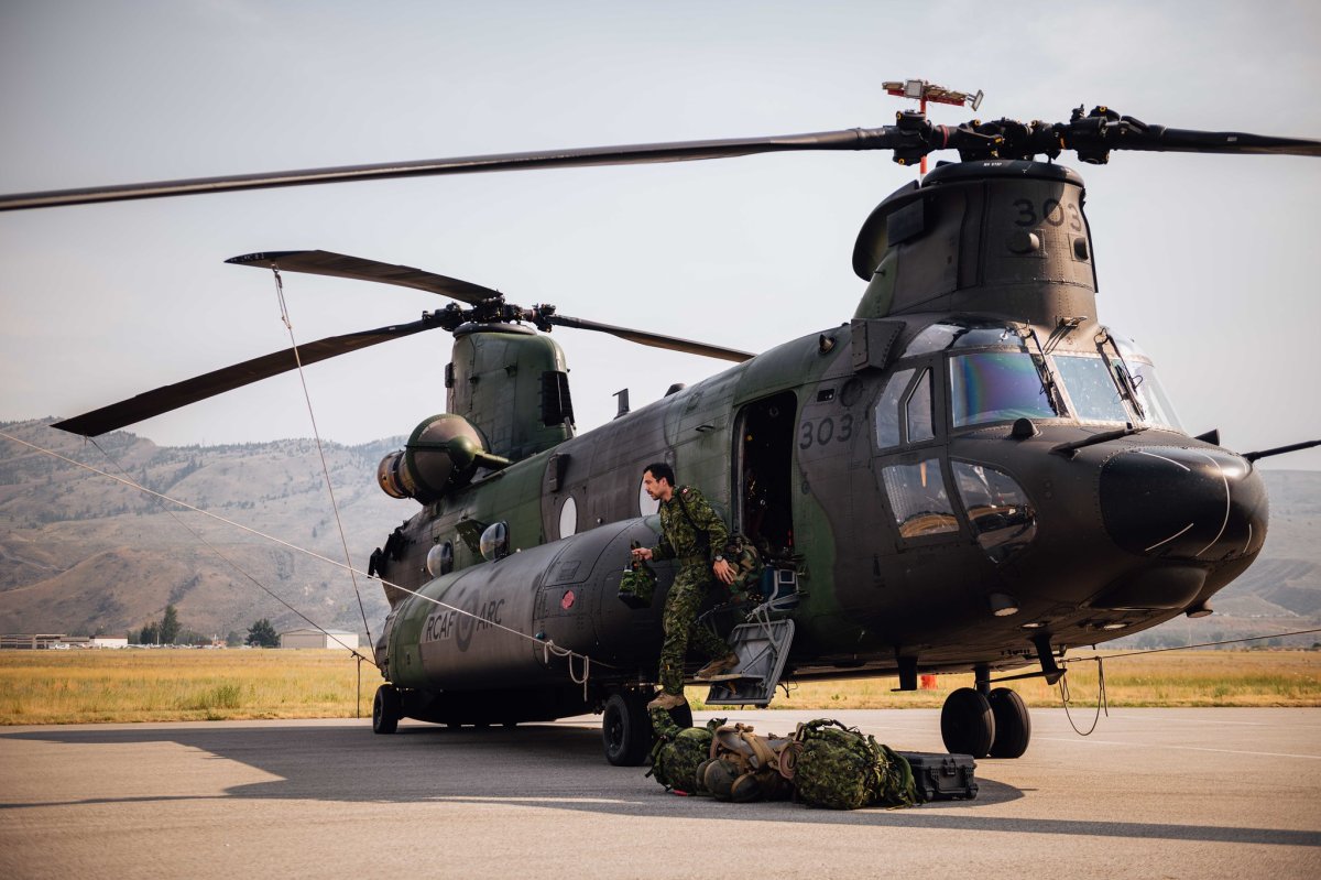 A Canadian Forces crew unloads a helicopter in B.C. in early July. 