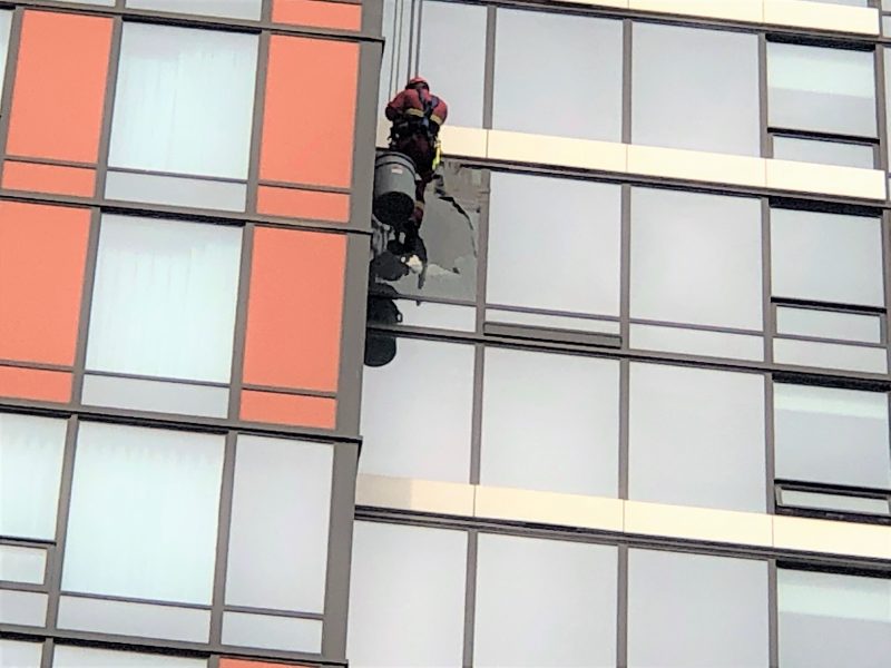 Members of the Calgary Fire Department respond to a broken window in the downtown core on Thursday, July 22, 2021. 