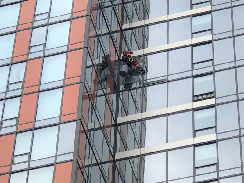 Members of the Calgary Fire Department respond to a broken window in the downtown core on Thursday, July 22, 2021.