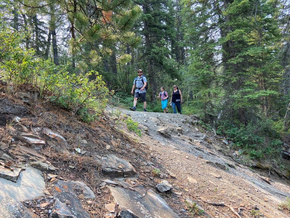 Auralia hiking with her parents.