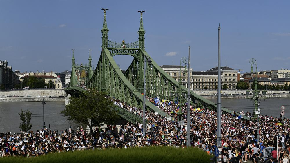 People march across the Szabadsag, or Freedom Bridge over the River Danube in downtown Budapest during a gay pride parade in Budapest, Hungary, Saturday, July 24, 2021. Rising anger over policies of Hungary's right-wing government filled the streets of the country's capital on Saturday as thousands of LGBT activists and supporters marched in the city's Pride parade. 