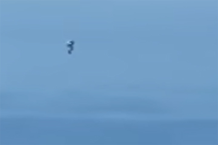This image from video posted Dec. 23, 2020, shows an object flying through the air off the coast of California.
