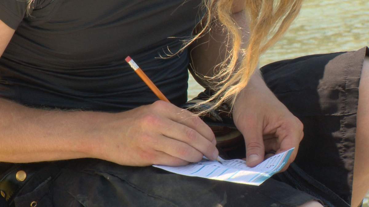 Nick Toews writes down all the garbage he’s collected so the Helen Schuler Nature Centre can keep track for the year.