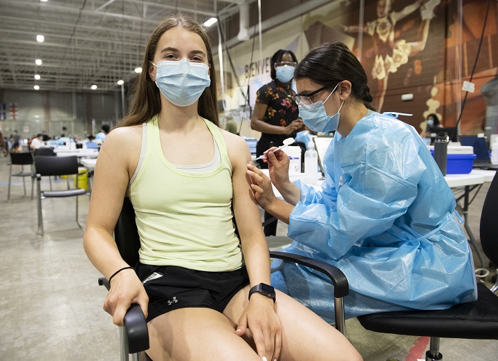 Noa Mendell (14) receives a COVID-19 vaccine shot from Laurence Dube at a COVID-19 vaccination site in Montreal, Saturday, May 22, 2021, as the COVID-19 pandemic continues in Canada and around the world. 
