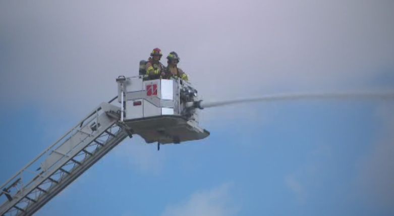 Edmonton firefighters work to extinguish a blaze in the river valley, Monday, July 5, 2021. 